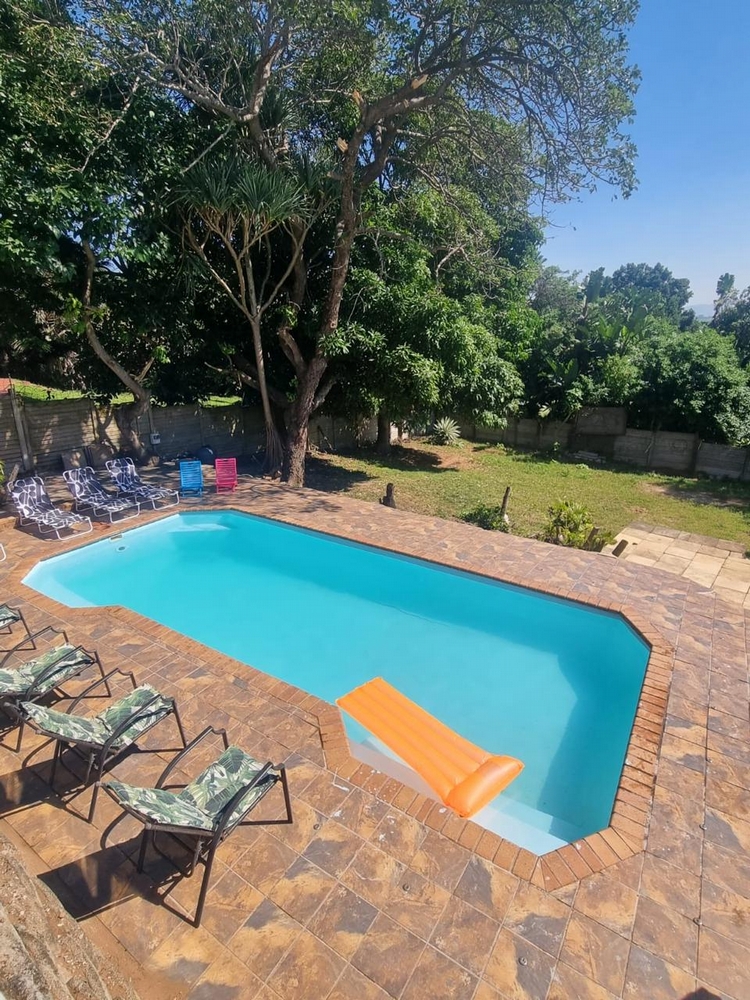 Deja Blu: Pool area with floaters and pool chairs.